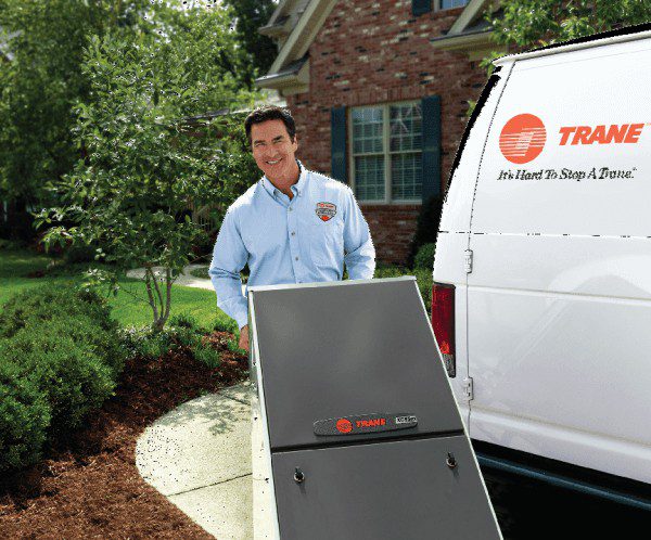 An installer wheels a new air handler in to a home
