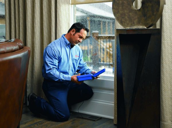 A Technician tests a floor vent in a home