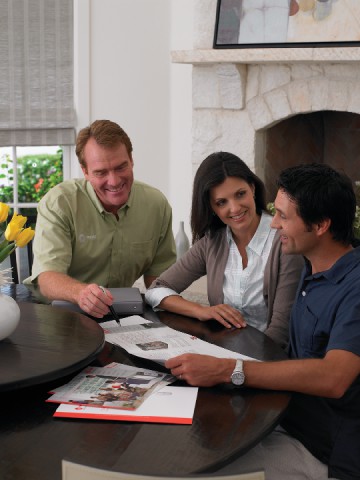 An Air Conditioning installer discusses options with a Coppell Homeowner