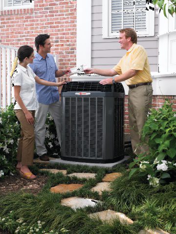 A couple talks to their AC Repairman