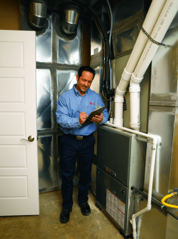 A tech checks a heater maintenance task off his list