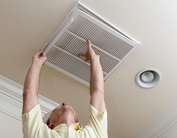 A technician replaces and air filter grille