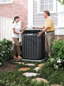 A service tech shows a Flower Mound homeowner the source of the problem