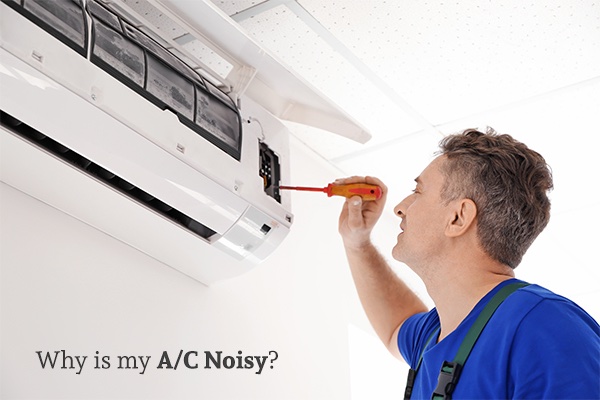 Man fixing an air conditioning unit with a screwdriver, with the words, why is my A/C noisy.
