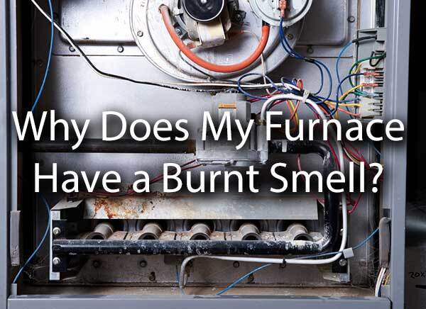 An old furnace with the words, "Why Does My Furnace Have a Burnt Smell?"