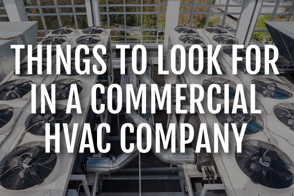 A commercial air conditioning unit with the words, "things to look for in a commercial HVAC comany."