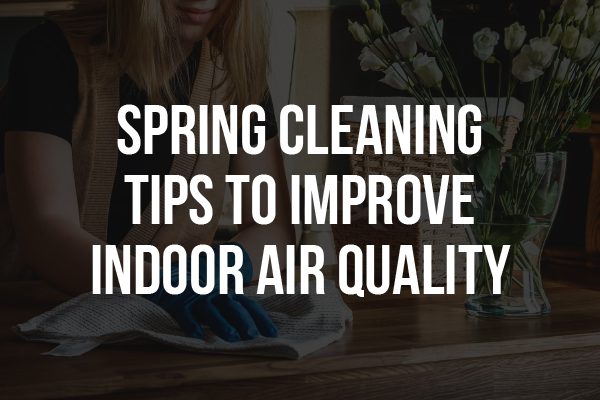 The words "spring cleaning tips to improve indoor air quality" in front of a person cleaning a table.